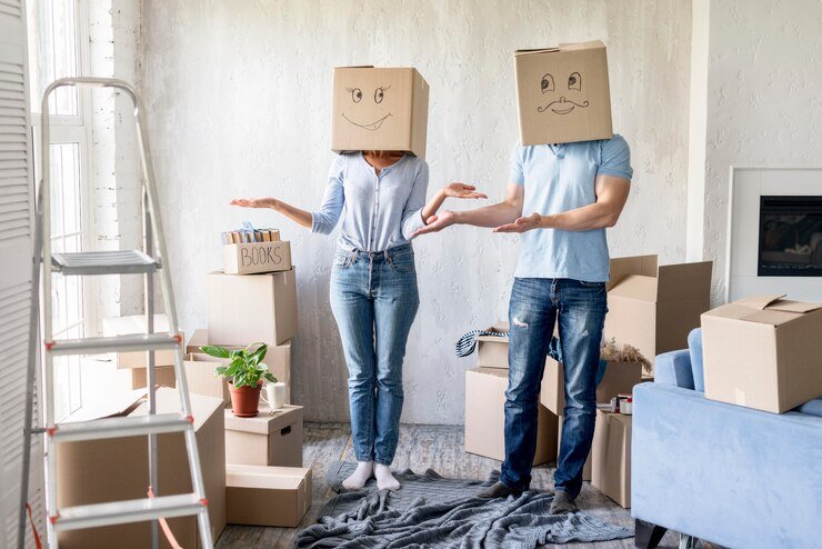 silly-couple-with-boxes-heads-moving-out-day_23-2148647479