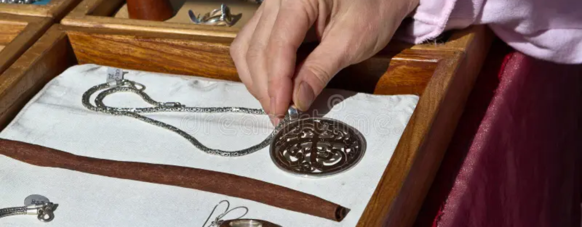 may-i-see-holiday-shopping-examining-necklace-laid-out-showcase-box-crafts-fair-stand-artisan-jewelry-35553945.jpg