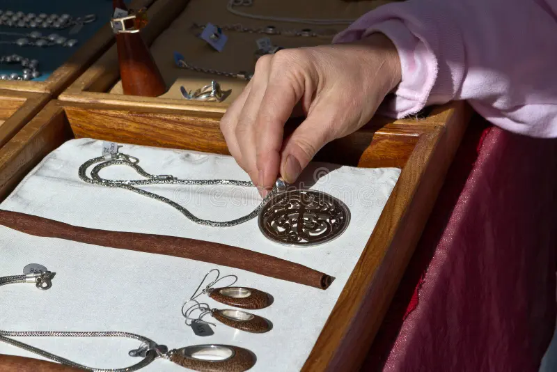 may-i-see-holiday-shopping-examining-necklace-laid-out-showcase-box-crafts-fair-stand-artisan-jewelry-35553945.jpg